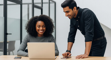 Diverse Team Collaborates Happily on Laptop in Modern Office
