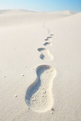 Single, deep footprint in fine, powdery sand, leading into a vast, bright expanse Low angle, wide shot of a single, deep footprint in fine, powdery white sand. The footprint leads the eye towards a