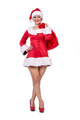 Festive woman dressed in a Santa costume holding a red gift sack, standing confidently on a transparent PNG background, perfect for holiday ads, banners, and seasonal designs.
