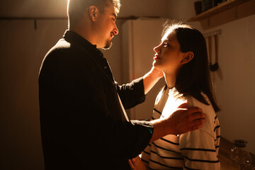 loving couple man and woman shares intimate moment in cozy kitchen