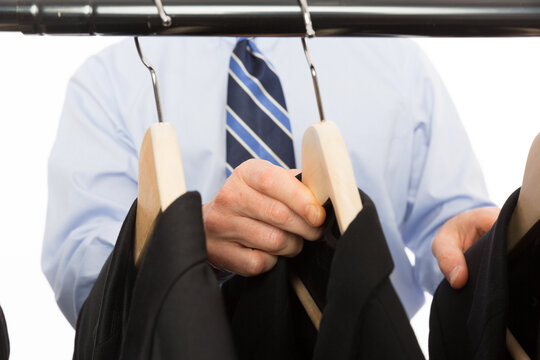 Close-up of male hands selecting suit