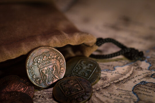 Voc gelderland obverse old gelderland voc coin lies beside a pouch and vintage map.