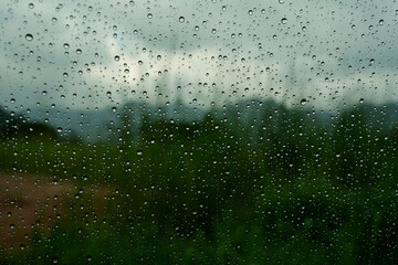 A closeup shot of the glass of a window covered by rain droplets for backgrounds and textures.
