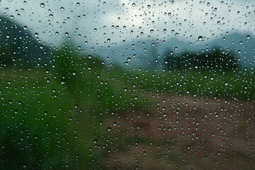 A closeup shot of the glass of a window covered by rain droplets for backgrounds and textures.