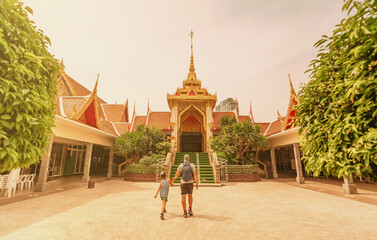 A father and son visit Wat Hua Lamphong, a Buddhist temple in Bangkok, Thailand. The temple is located near Sam Yan MTR Station and Hua Lamphong Train Station.