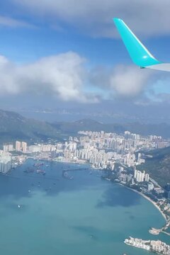 Coastal skyline rises beside shimmering blue waters.