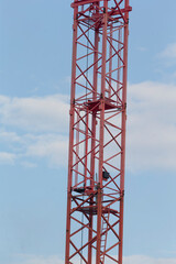 unfinished concrete slab with yellow safety rails and lamp. gritty construction detail showing anchors,
