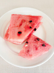 Watermelon sliced ​​in a white plate. Summer time.