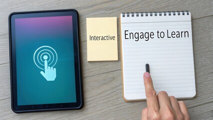 Finger touching notepad and tablet screen to engage interactivity