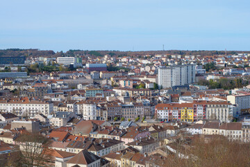 A high-quality cityscape of downtown &Eacute;pinal, located in the Vosges region of northeastern France. The image showcases the harmonious blend of historic French architecture, modern urban elements