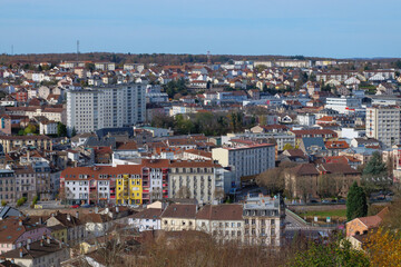 A high-quality cityscape of downtown &Eacute;pinal, located in the Vosges region of northeastern France. The image showcases the harmonious blend of historic French architecture, modern urban elements