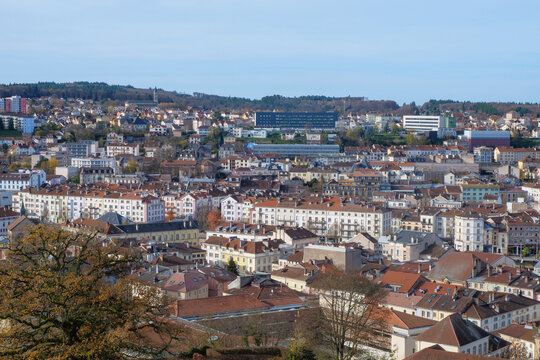 A high-quality cityscape of downtown &Eacute;pinal, located in the Vosges region of northeastern France. The image showcases the harmonious blend of historic French architecture, modern urban elements