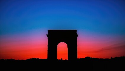 Fototapeta premium Vibrant sunset casting shadows on an archway, evoking a sense of tranquility