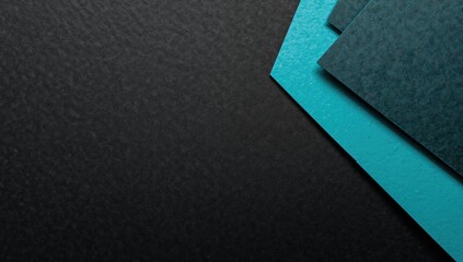 Fototapeta premium Texture of black and turquoise paper with geometric shapes and patterns, suitable for editorial header background