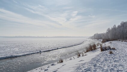 Naklejka premium Snowy field with an ice-covered river, seasonal change
