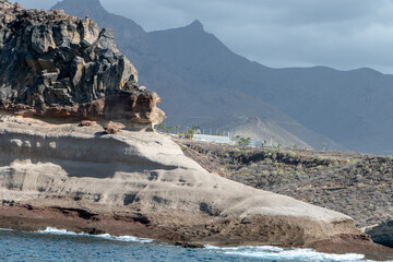 Southern Tenerife coastline from a boat with cliffs and mountains