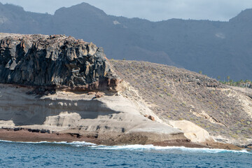 Southern Tenerife coastline from a boat with cliffs and mountains