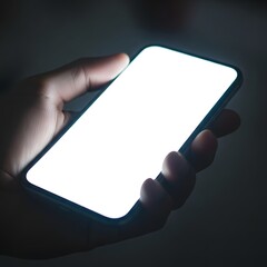 A person holding a smartphone with a bright screen in a dark environment, showcasing modern technology and digital communication