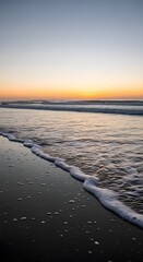A serene beach scene at sunset with gentle waves washing onto the sandy shore under a colorful sky