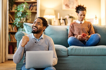 Portrait of a young black man and woman, a young couple, or businessman and businesswoman, using laptop in home office, business and teamwork, cooperation and brainstorming concept