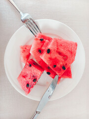 Watermelon sliced ​​in a white plate. Summer time.