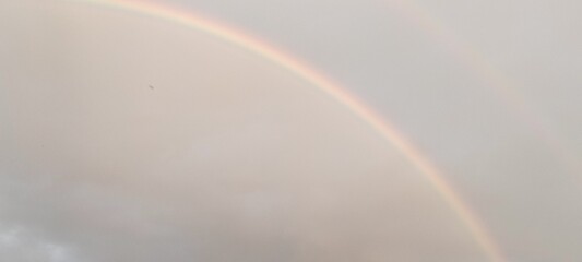 rainbow on a blue sky,good luck,beautiful nature,Use as a greeting card background.,book cover
