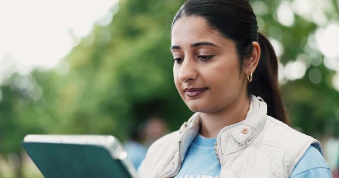 Volunteer, woman outdoor or scroll with tablet for NGO donation website, outreach or nonprofit service. Bokeh, person or reading with tech in park for charity work, social responsibility and project.