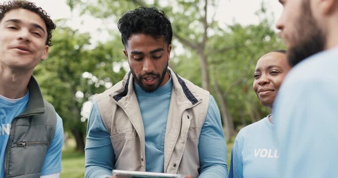 Volunteer, outdoor and man in meeting, tablet and conversation with NGO donation project. Group, men and women in park, tech and social responsibility with charity event, community service and app