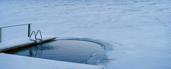 Finland. Ice swimming in a lake covered in ice