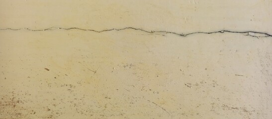 Horizontal Thick Crack On Faded Beige Painted Wall Texture