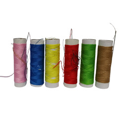A vibrant collection of six colorful sewing threads with needles, isolated on a clean transparent background for crafting projects
