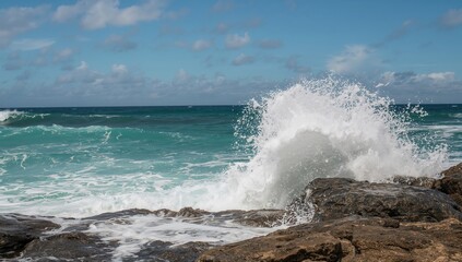 Waves crashing against a rocky shoreline, showcasing natural beauty and erosion risk