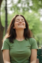 Green t-shirt woman relaxes with smile on sunny park bench