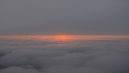 Panoramic view of a grey sky illuminated by warm orange sunlight, evoking tranquility