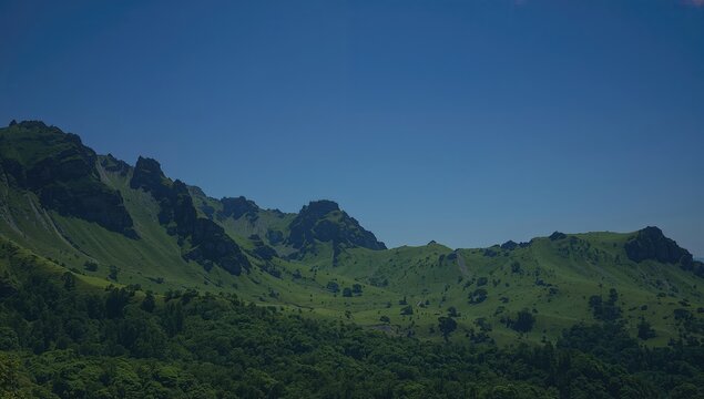Mountains, lush green grass, and a vibrant blue sky form the scenic landscape, seasonal change