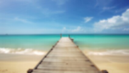 Blurred beach with wooden elements, serene backdrop for relaxation