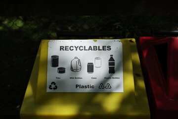 Recycling bin with sorting pictogram on yellow lid