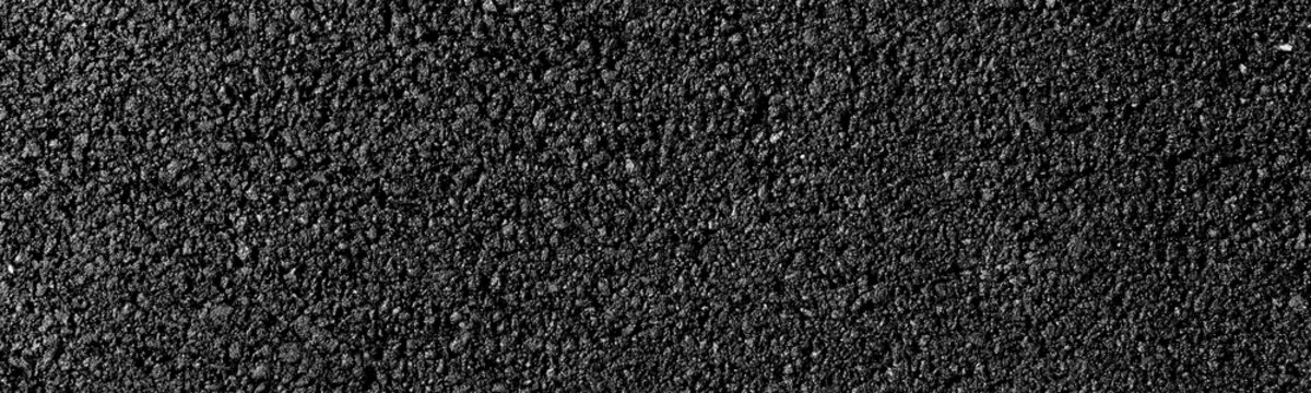 close-up texture of smooth, freshly laid asphalt surface with fine granules and a uniform appearance, neutral background, clear negative space, clean composition, balanced framing, minimalist layout