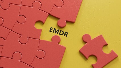 Fototapeta premium The text EMDR word Eye Movement Desensitization is written on notepad . Medical concept.close up of puzzle pieces with missing pieces,Business Concept.3D rendering.