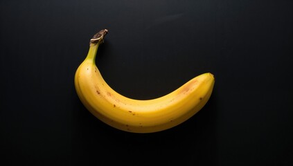 Yellow banana against a dark backdrop, nutritious tropical fruit choice