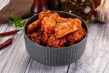 Raw marinated buffalo chicken wings