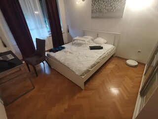 Bright bedroom with white bed and tray table