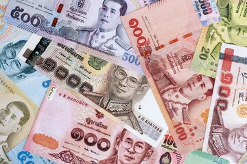 Thai baht currency money. The current banknotes lies on table in big amount close up