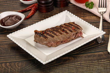 Grilled beef striploin steak with sauce