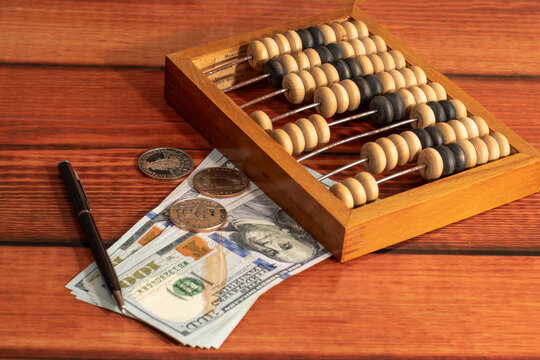 Business: money, wooden abacus and pen