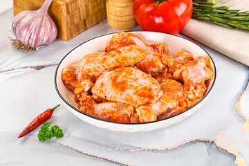 Raw marinated uncooked chicken wings