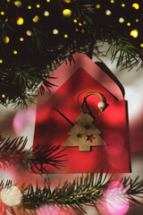 Christmas letters, short notes, enclosed in an envelope with a postcard or in a parcel bag with a gift. Christmas tree, envelope, greeting card, postcard, reminder.  String light creates festive mood