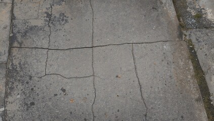 Obraz premium Aerial perspective of weathered asphalt road featuring visible cracks, highlighting erosion risk