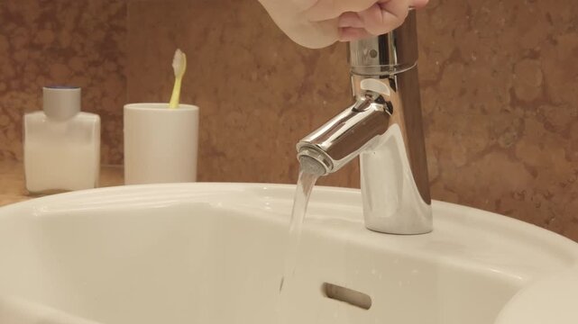 washing hands in sink, morning skincare routine in interior, Self-care and mindfulness, basic hygiene, chrome European plumbing