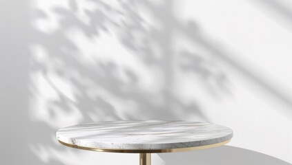 Obraz premium Round marble tabletop with tree leaf shadows on a white wall, suitable for product mockup display